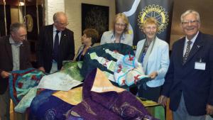 Members and partners reviewing the textiles with President Elect Mary Fraser, Joyce and Bob Watson.